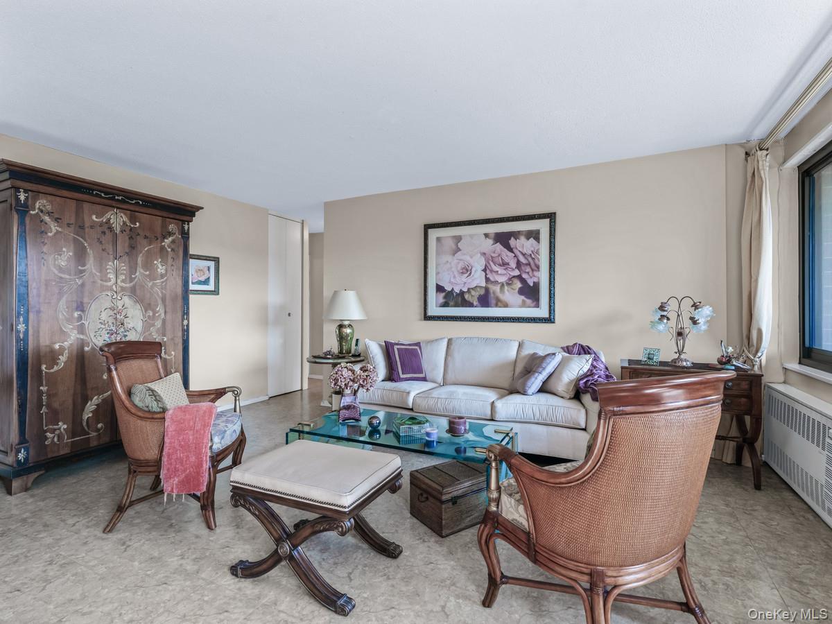 77 Fulton Street, Unit 19C Manhattan, NY 10038 - Photo 7 of 20 a living room with furniture a rug and a large window