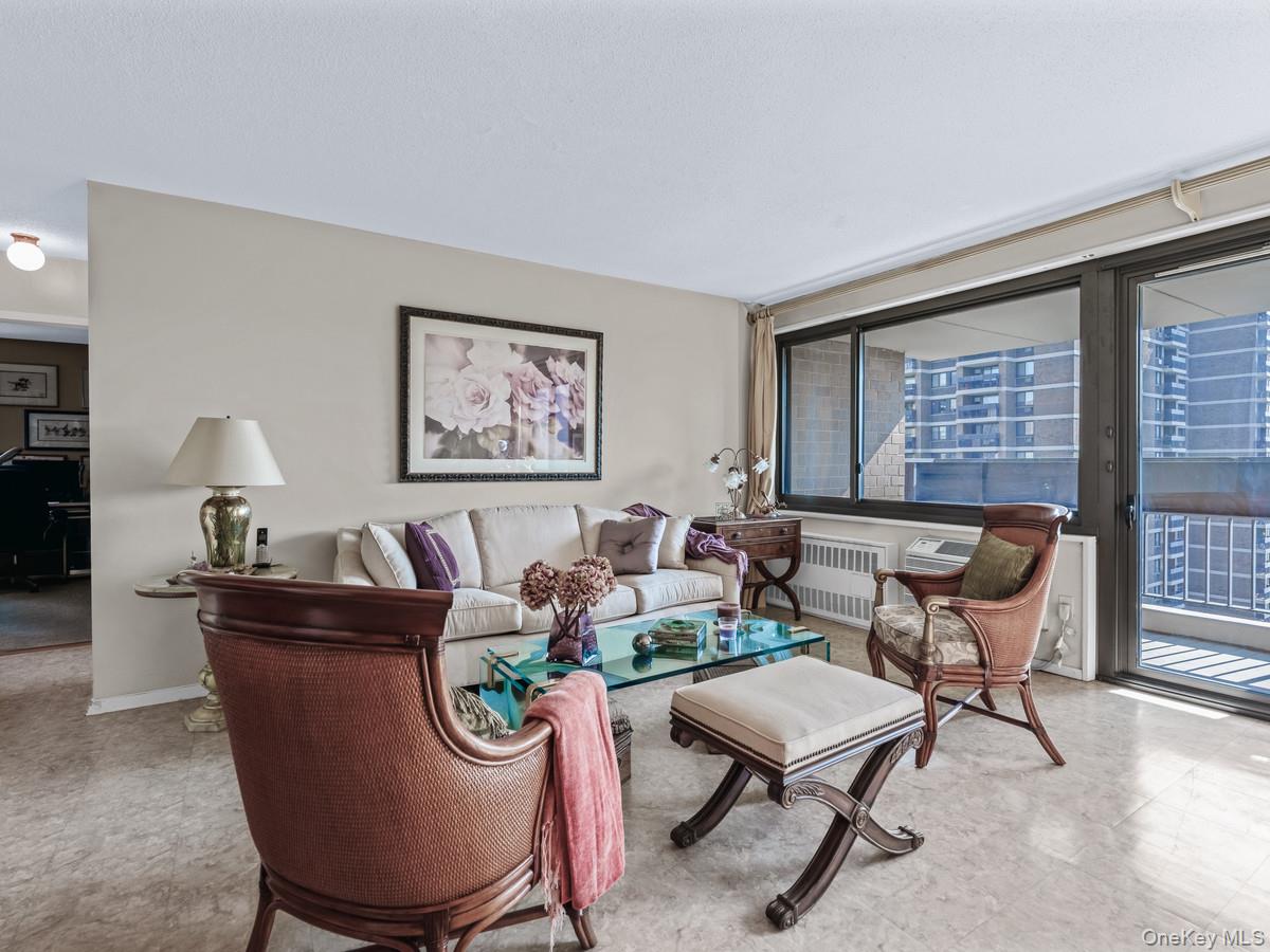 77 Fulton Street, Unit 19C Manhattan, NY 10038 - Photo 8 of 20 a living room with furniture and a potted plant