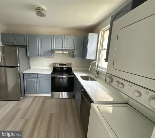 a kitchen with a sink a stove and a refrigerator