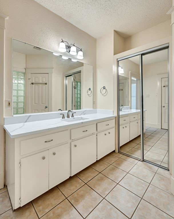 106 30th Street North Waco, TX 76710 - Photo 22 of 47 a spacious bathroom with a granite countertop sink a mirror and a