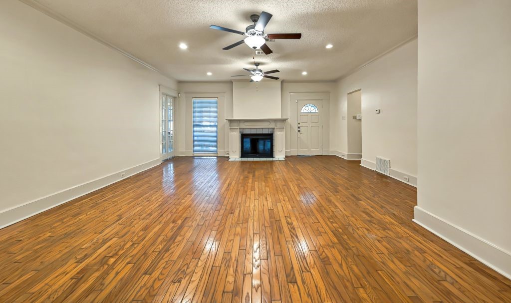 106 30th Street North Waco, TX 76710 - Photo 6 of 47 wooden floor in an empty room with a fireplace