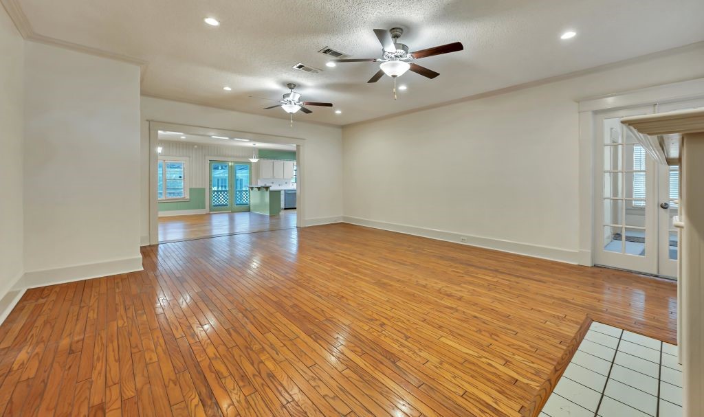 106 30th Street North Waco, TX 76710 - Photo 7 of 47 a view of an empty room with wooden floor and a kitchen