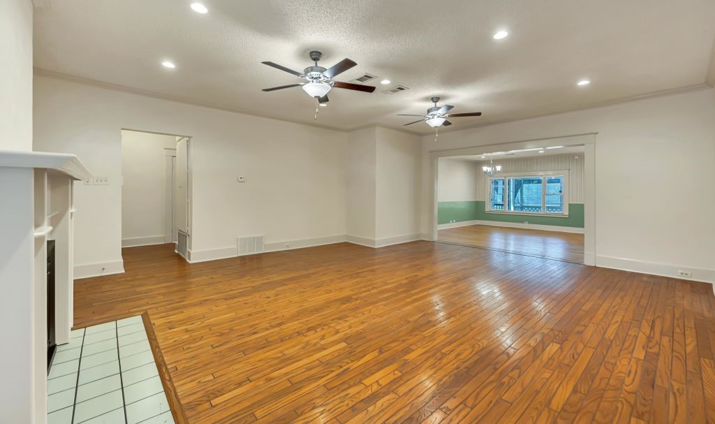106 30th Street North Waco, TX 76710 - Photo 8 of 47 a view of an empty room with wooden floor and a ceiling fan