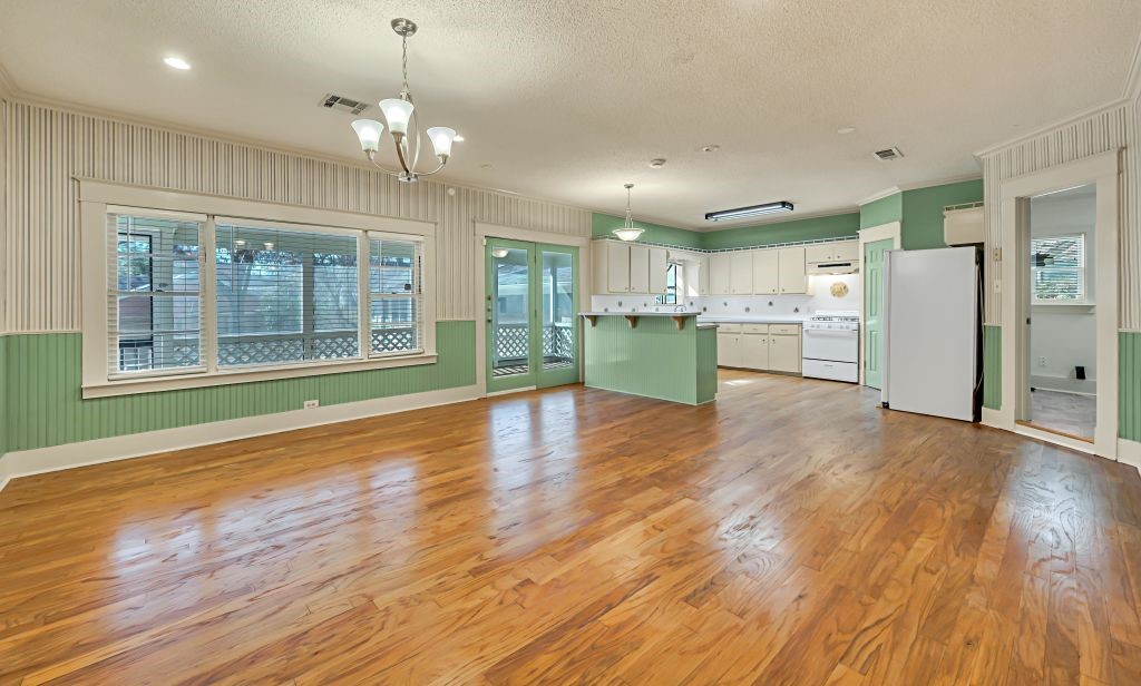 106 30th Street North Waco, TX 76710 - Photo 9 of 47 a view of a kitchen with a fridge wooden floor and a window