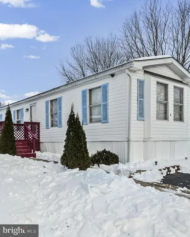 a view of a house with snow in the background