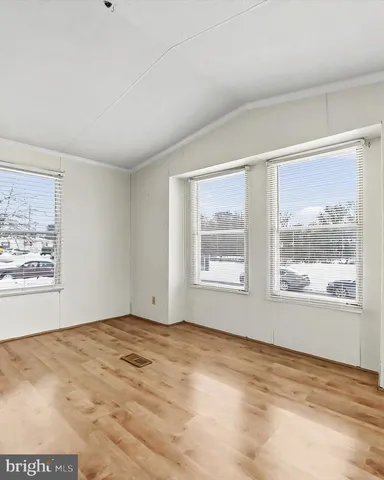 a spacious bedroom with a bed and a large window