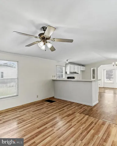 a big room with wooden floor and windows