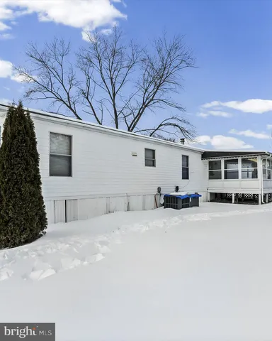 a view of a house with a snow in front of yard