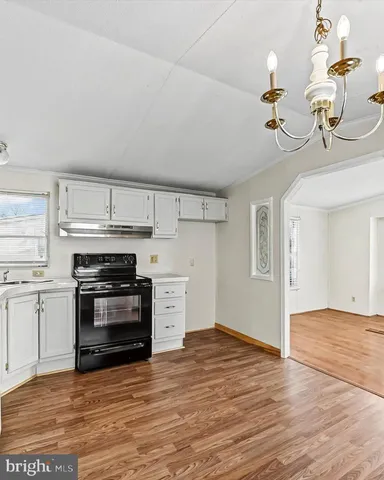 a kitchen with a stove a sink and a refrigerator