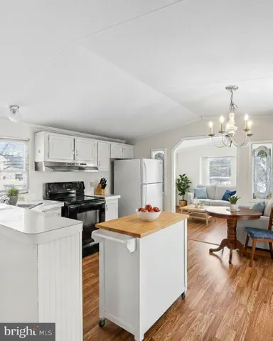 a kitchen with a stove a refrigerator and a fireplace