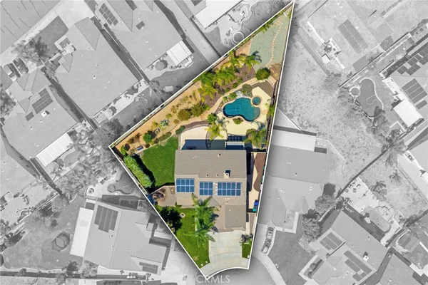 an aerial view of a house with a yard and potted plants