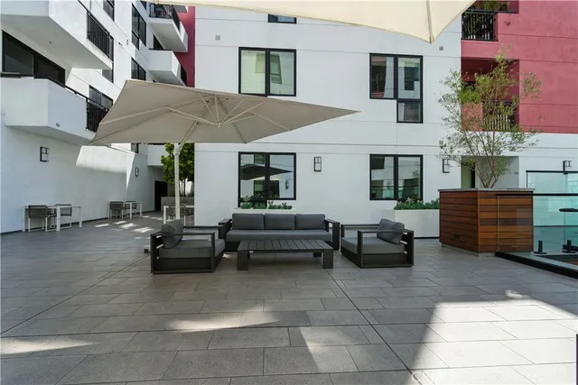 a view of a patio with dining table and chairs