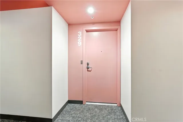 a large kitchen with stainless steel appliances granite countertop a stove a sink a refrigerator and white cabinets with wooden floor