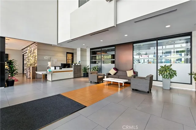 a living room with furniture and floor to ceiling window