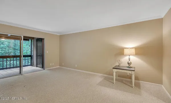 a view of empty room with sliding door