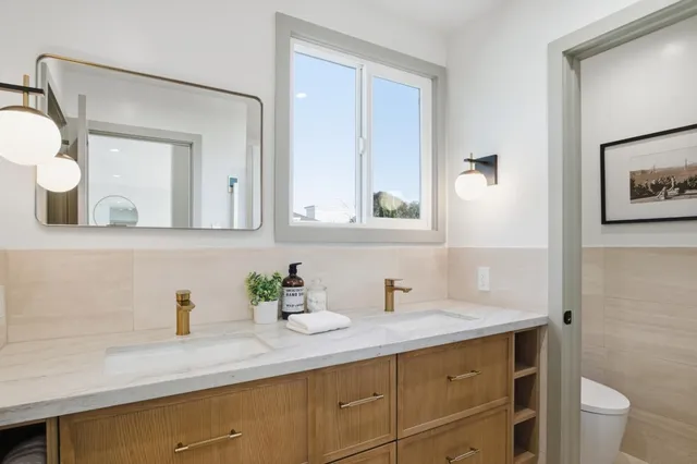 a view of backyard with wooden fence and a large tree