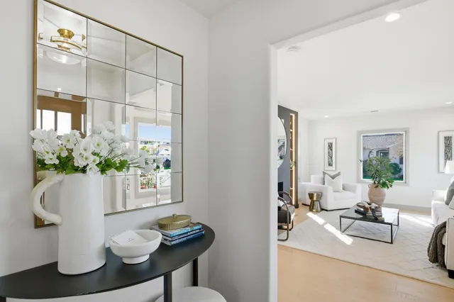 a bedroom with a large bed and a chandelier