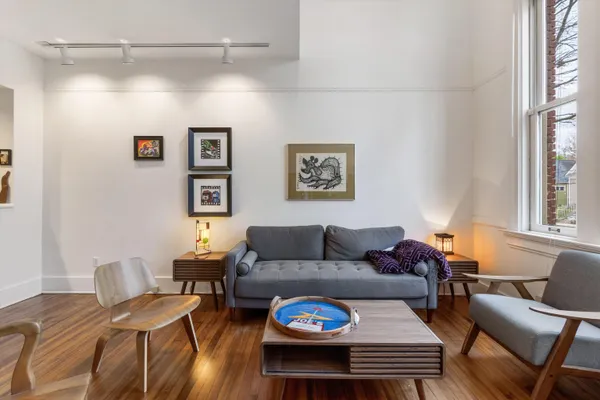 a living room with furniture a wooden floor and a window