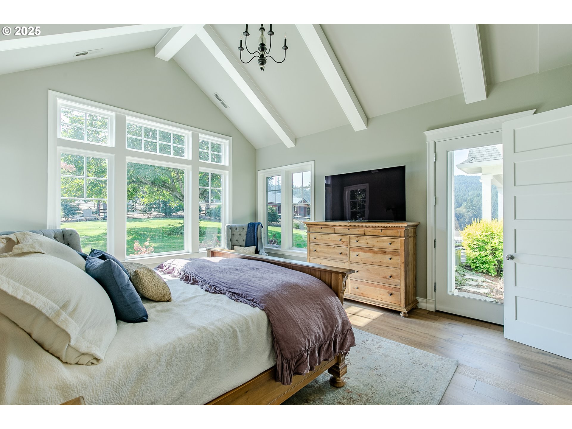27716 Erickson Road Eugene, OR 97402 - Photo 12 of 40 a bedroom with a bed and a flat tv screen