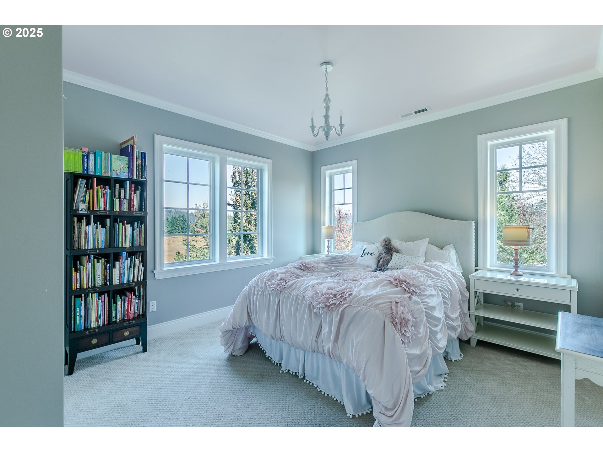 27716 Erickson Road Eugene, OR 97402 - Photo 14 of 40 a bedroom with a bed a bookshelf and a window