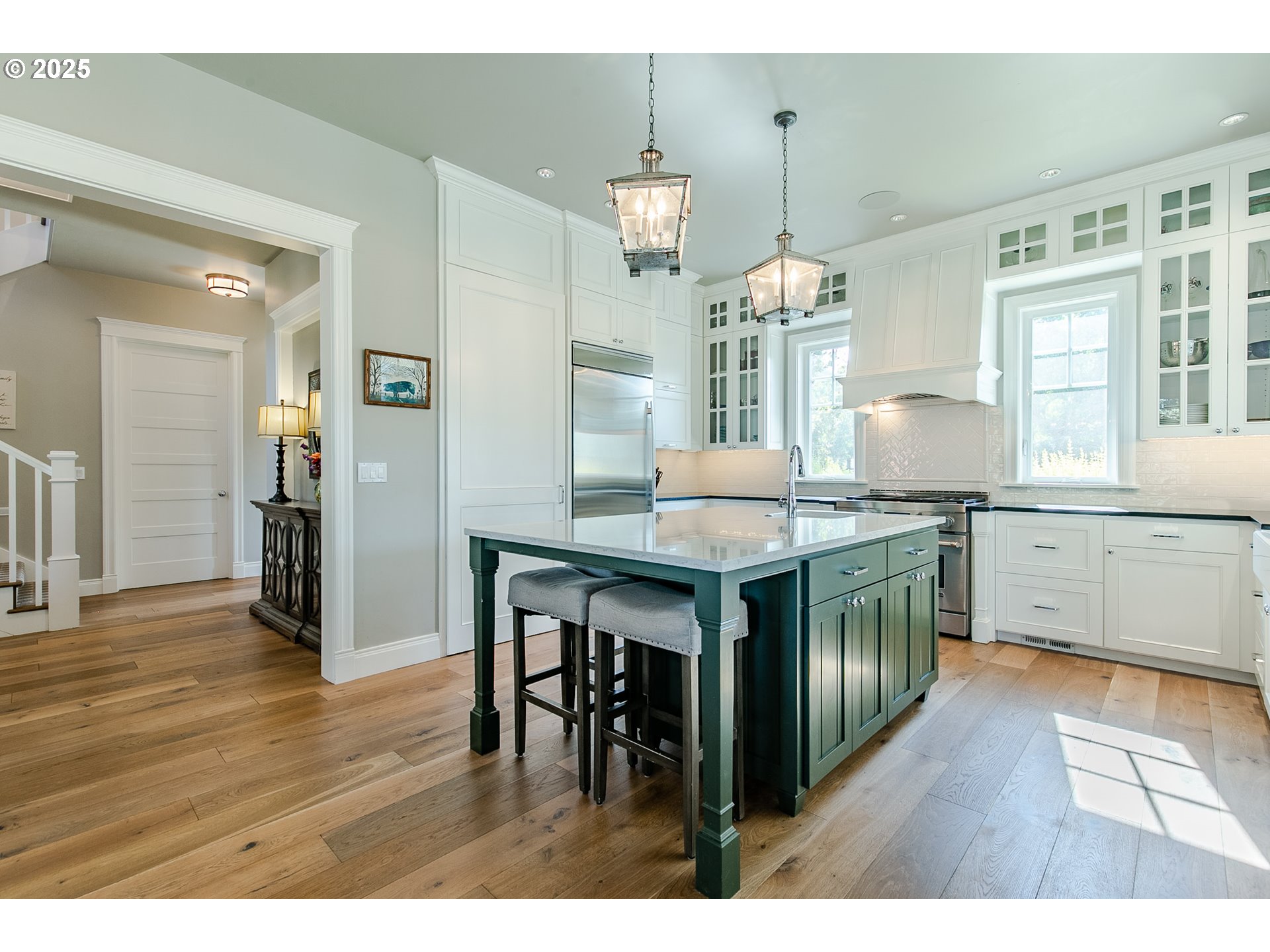 27716 Erickson Road Eugene, OR 97402 - Photo 6 of 40 a kitchen with granite countertop a stove a sink dishwasher a dining table and chairs with wooden floor
