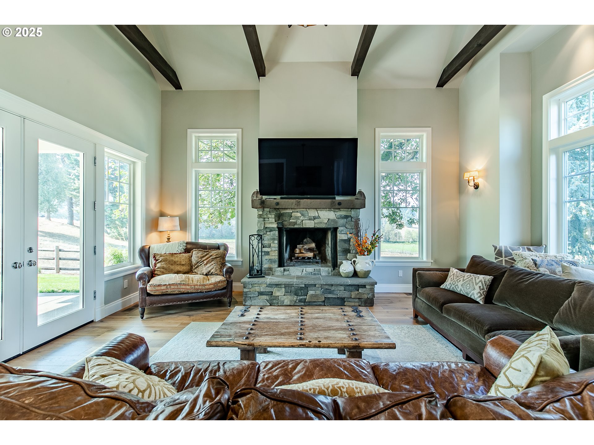 27716 Erickson Road Eugene, OR 97402 - Photo 9 of 40 a living room with furniture a flat screen tv and a fireplace