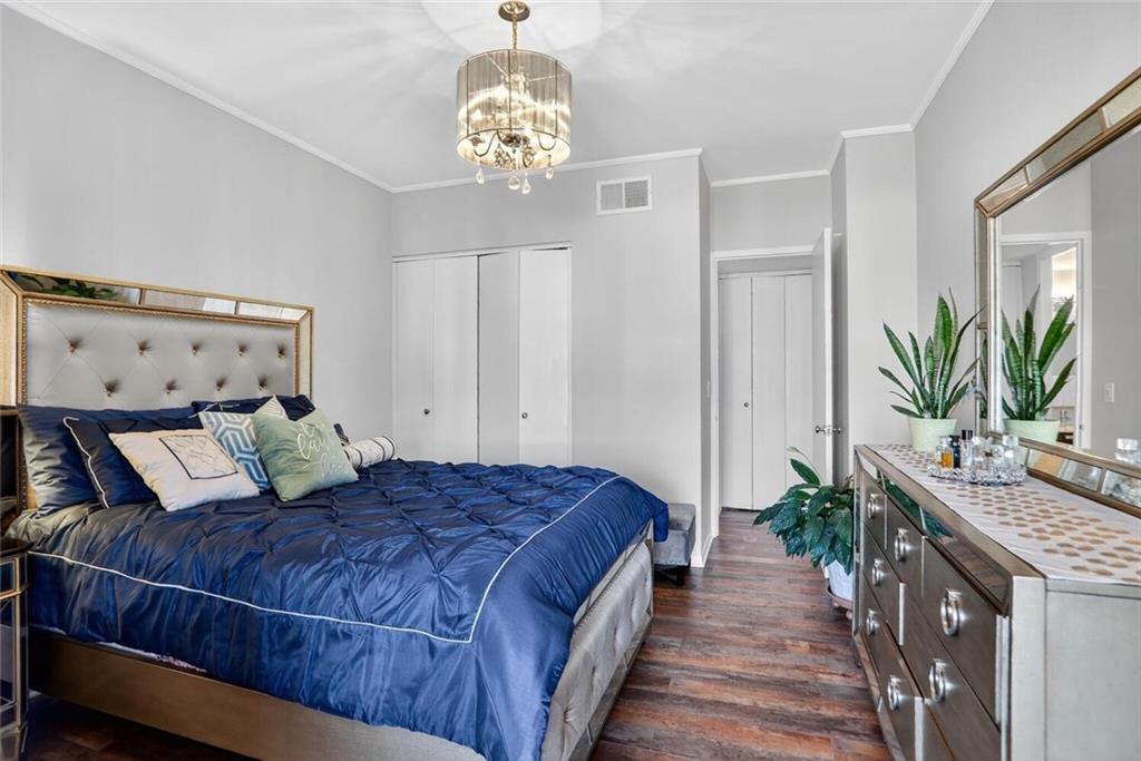 130 26th Street Northwest, Unit 804 Atlanta, GA 30309 - Photo 13 of 25 a bedroom with a large bed and a chandelier