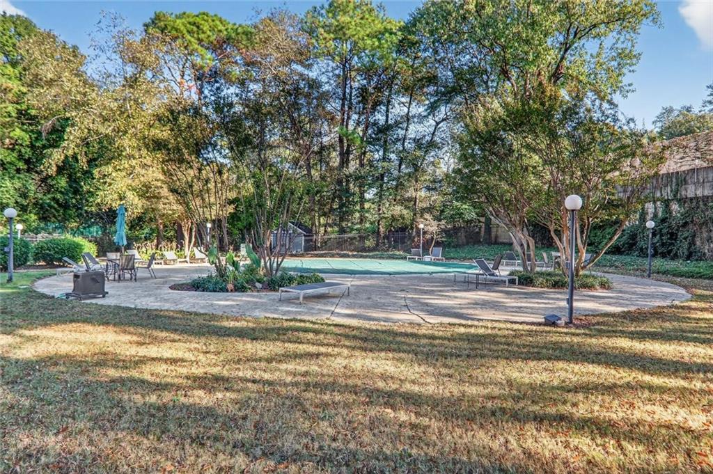 130 26th Street Northwest, Unit 804 Atlanta, GA 30309 - Photo 17 of 25 a view of a house with a big yard and large trees