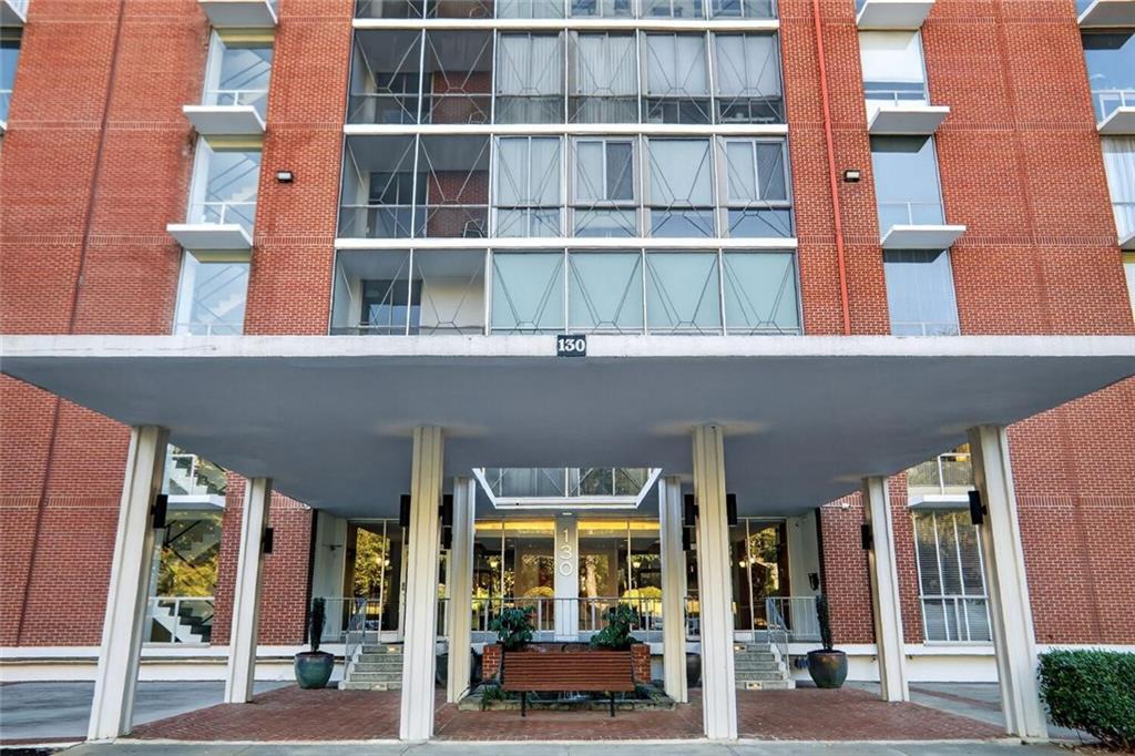 130 26th Street Northwest, Unit 804 Atlanta, GA 30309 - Photo 3 of 25 a front view of a building with a porch