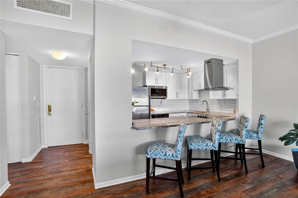 130 26th Street Northwest, Unit 804 Atlanta, GA 30309 - Photo 8 of 25 a dining room with furniture and wooden floor