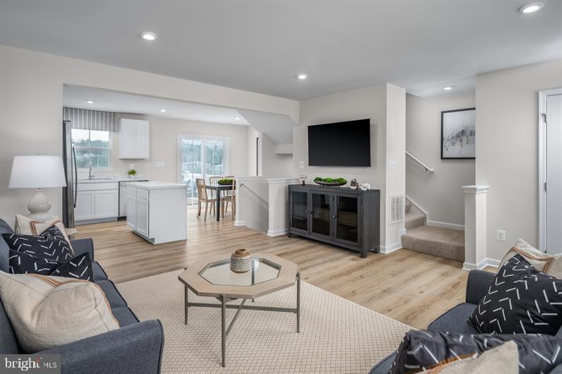 23 Debra Lane, Unit 53B Carlisle, PA 17013 - Photo 10 of 19 a living room with furniture a flat screen tv and kitchen view