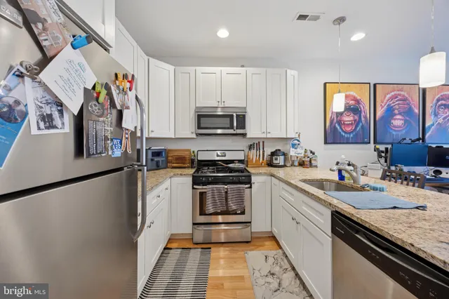a kitchen with stainless steel appliances granite countertop a stove and a sink