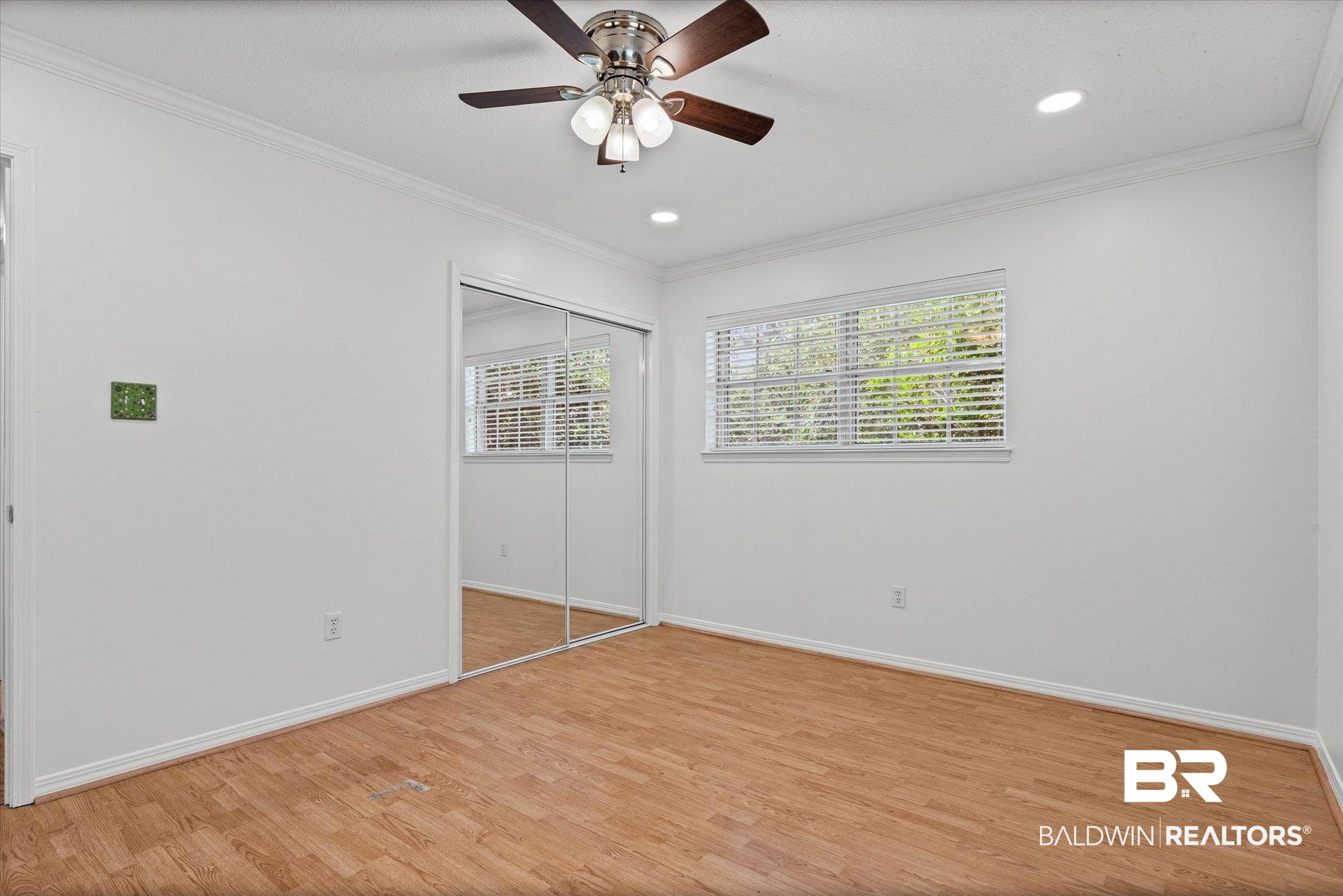 8301 Fordham Road Mobile, AL 36619 - Photo 18 of 57 Room featuring wood-finish flooring, white walls, and crown molding