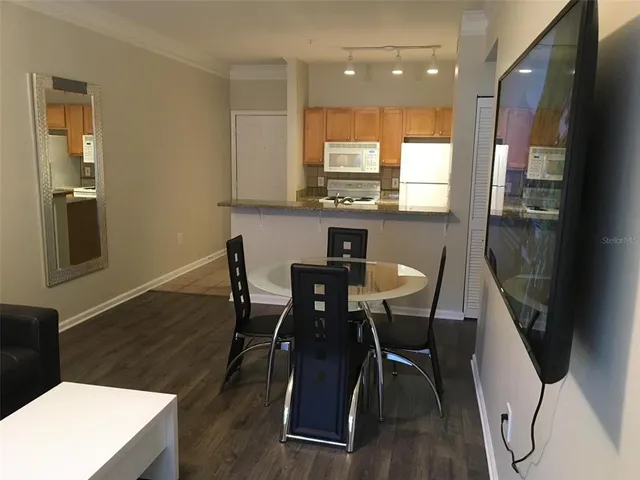 a view of a dining room with furniture and wooden floor