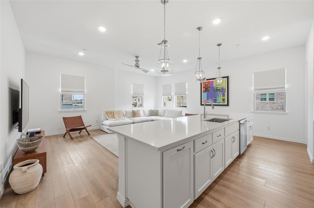 634 Blue Rdg Drive Mansfield, TX 76063 - Photo 5 of 25 a large white kitchen with wooden floor and a sink
