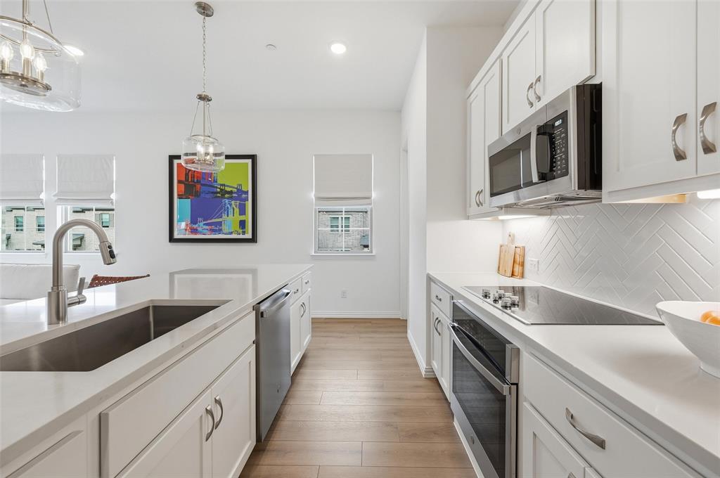 634 Blue Rdg Drive Mansfield, TX 76063 - Photo 7 of 25 a kitchen with stainless steel appliances granite countertop a sink and a stove top oven