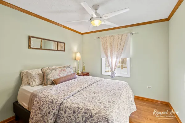 a bedroom with a large bed and a chandelier