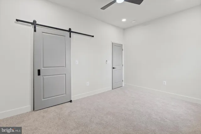 an empty room with a ceiling fan and window