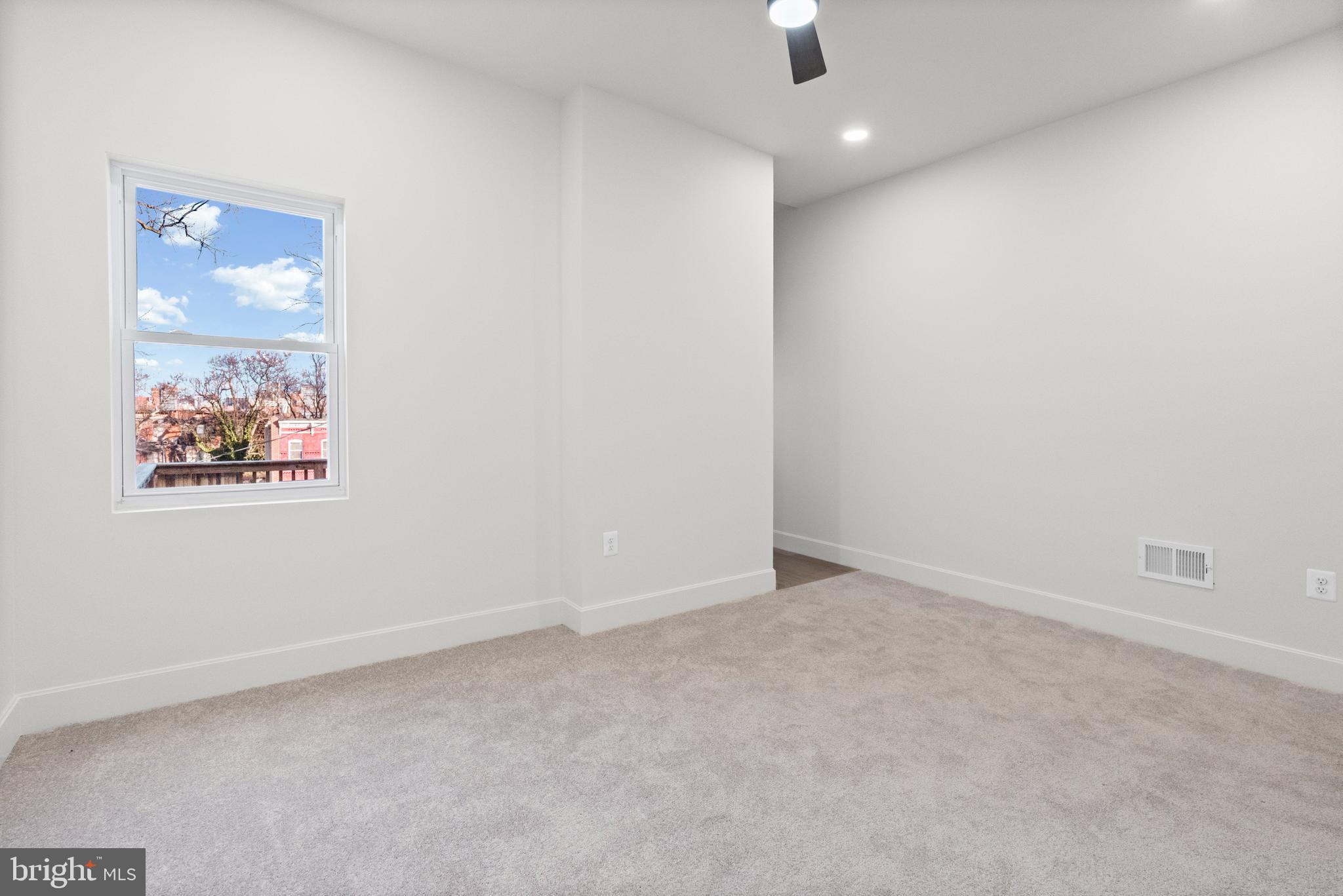 317 South Fulton Avenue Baltimore, MD 21223 - Photo 16 of 44 an empty room with a ceiling fan and window