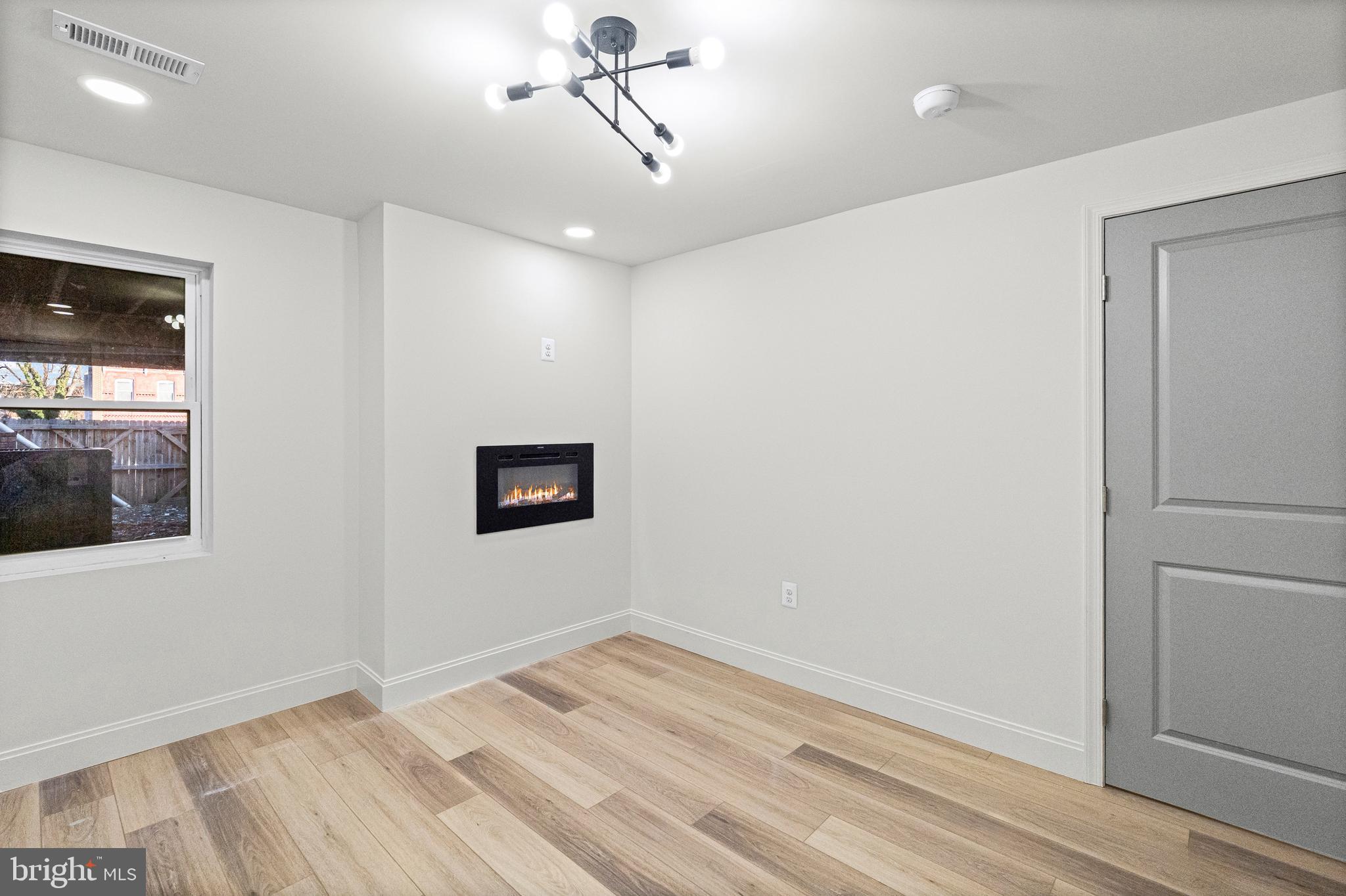 317 South Fulton Avenue Baltimore, MD 21223 - Photo 17 of 44 a view of empty room with wooden floor