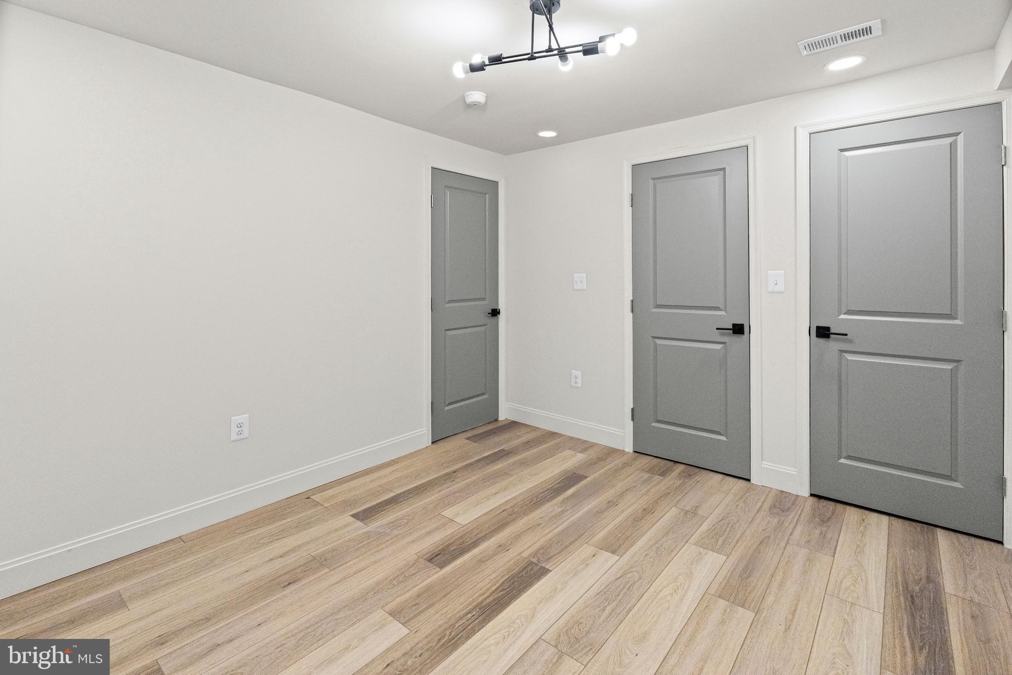 317 South Fulton Avenue Baltimore, MD 21223 - Photo 19 of 44 a view of an empty room with wooden floor
