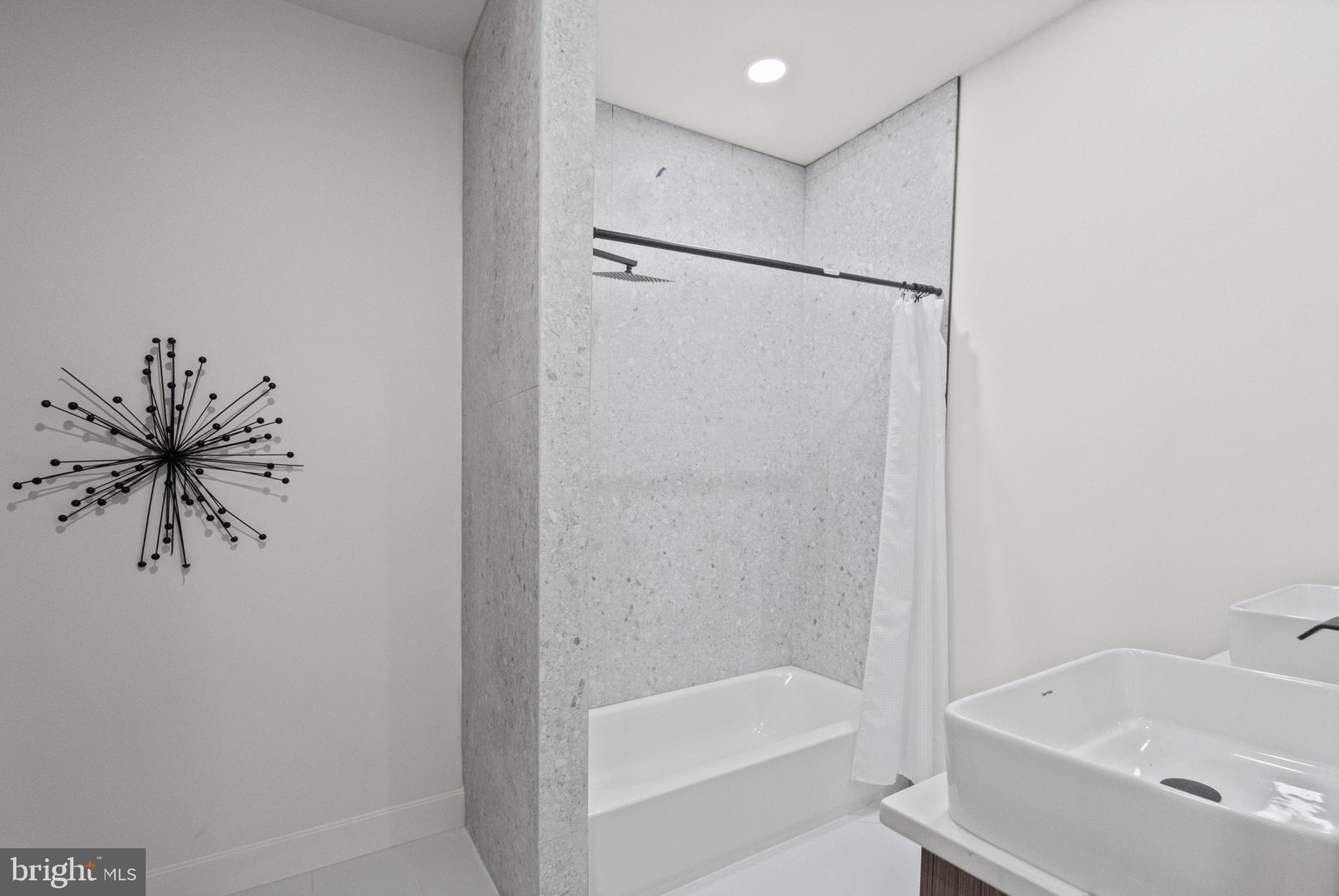 317 South Fulton Avenue Baltimore, MD 21223 - Photo 21 of 44 a bathroom with a bathtub and a shower