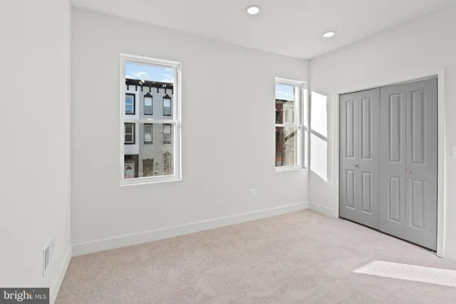 a kitchen with stainless steel appliances kitchen island granite countertop a refrigerator stove and oven