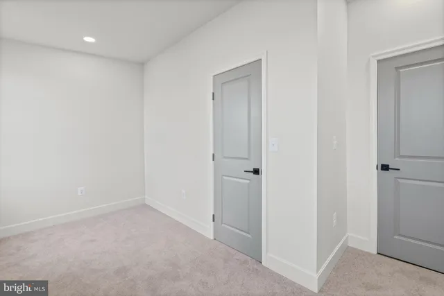 a kitchen with a refrigerator and a stove top oven