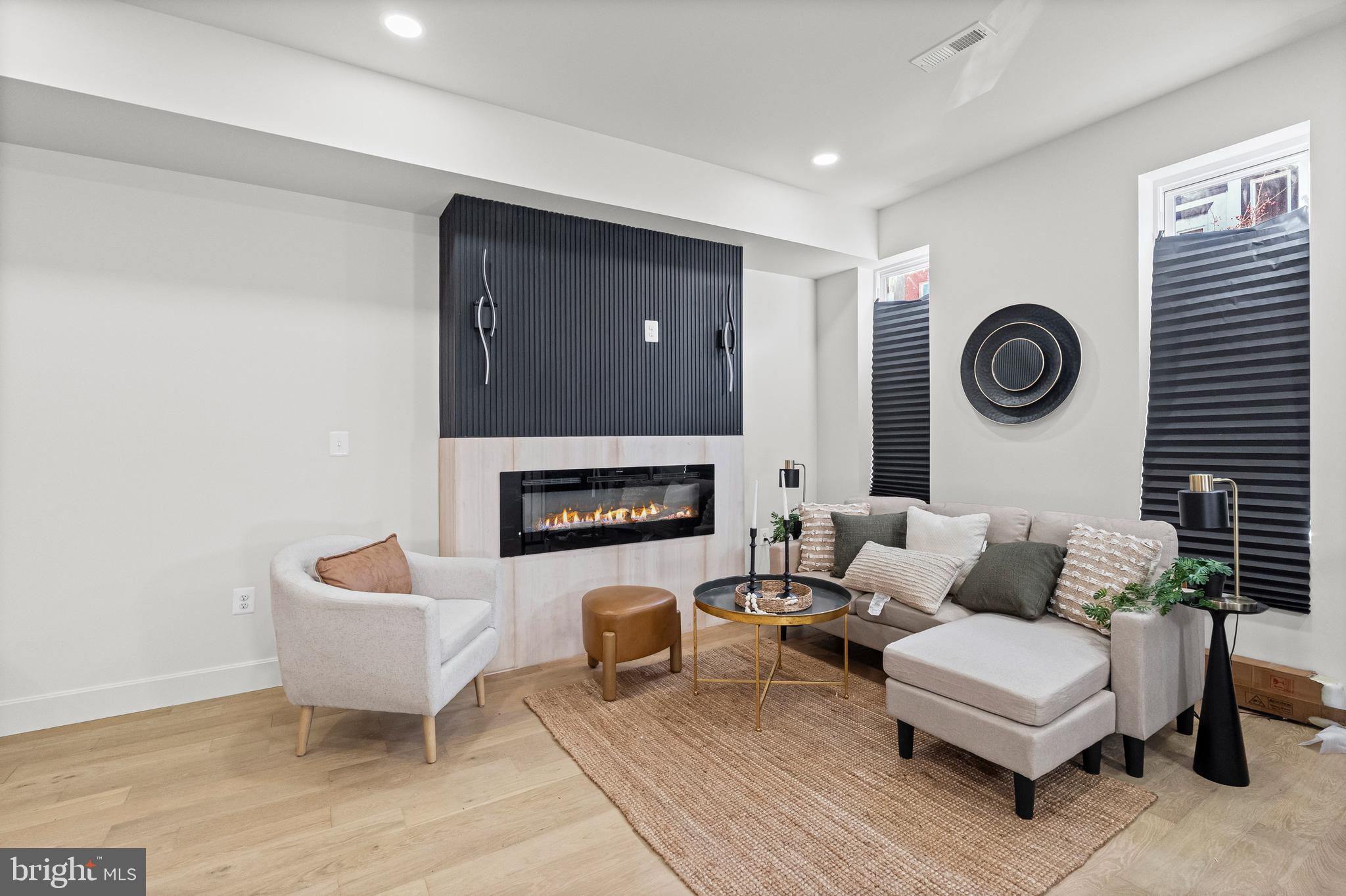 317 South Fulton Avenue Baltimore, MD 21223 - Photo 3 of 44 a living room with furniture and a fireplace