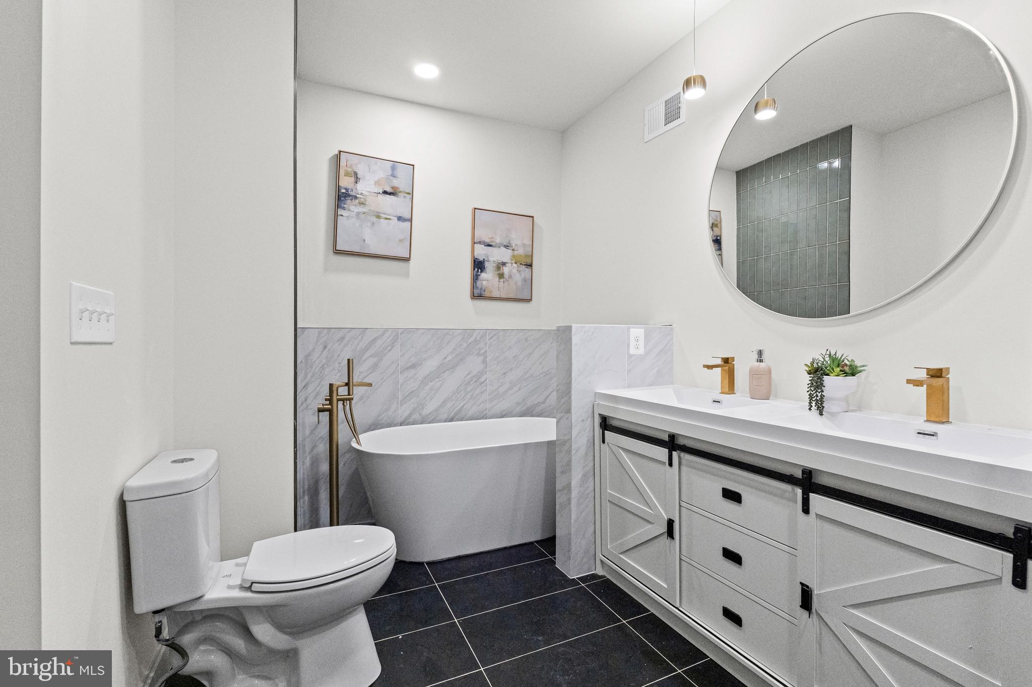 317 South Fulton Avenue Baltimore, MD 21223 - Photo 31 of 44 a bathroom with a toilet sink and mirror