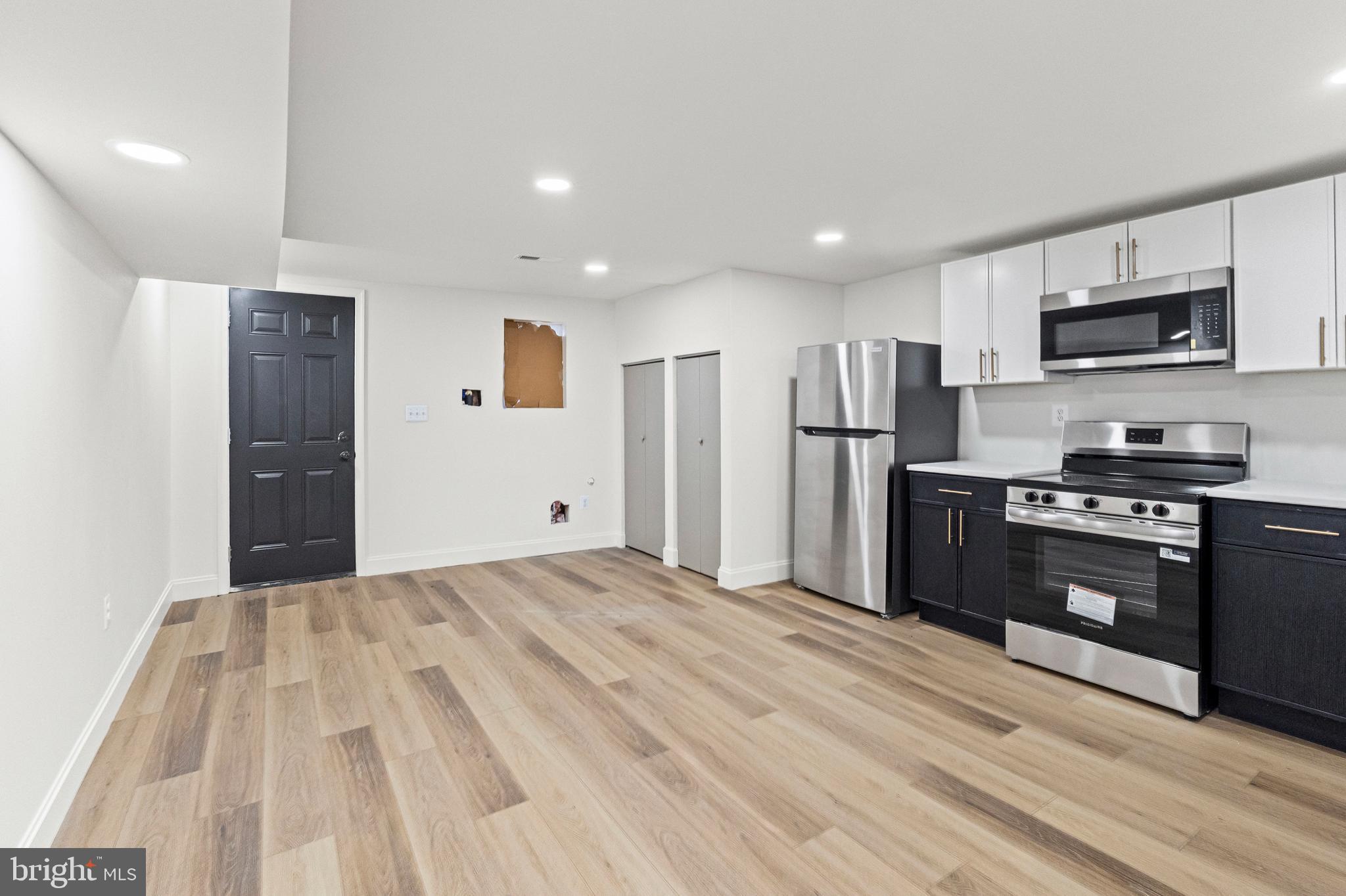 317 South Fulton Avenue Baltimore, MD 21223 - Photo 34 of 44 a kitchen with stainless steel appliances kitchen island granite countertop a refrigerator stove and oven
