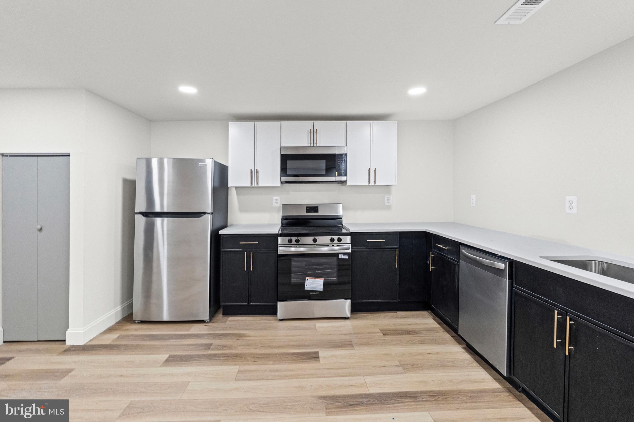317 South Fulton Avenue Baltimore, MD 21223 - Photo 37 of 44 a kitchen with a refrigerator and a stove top oven
