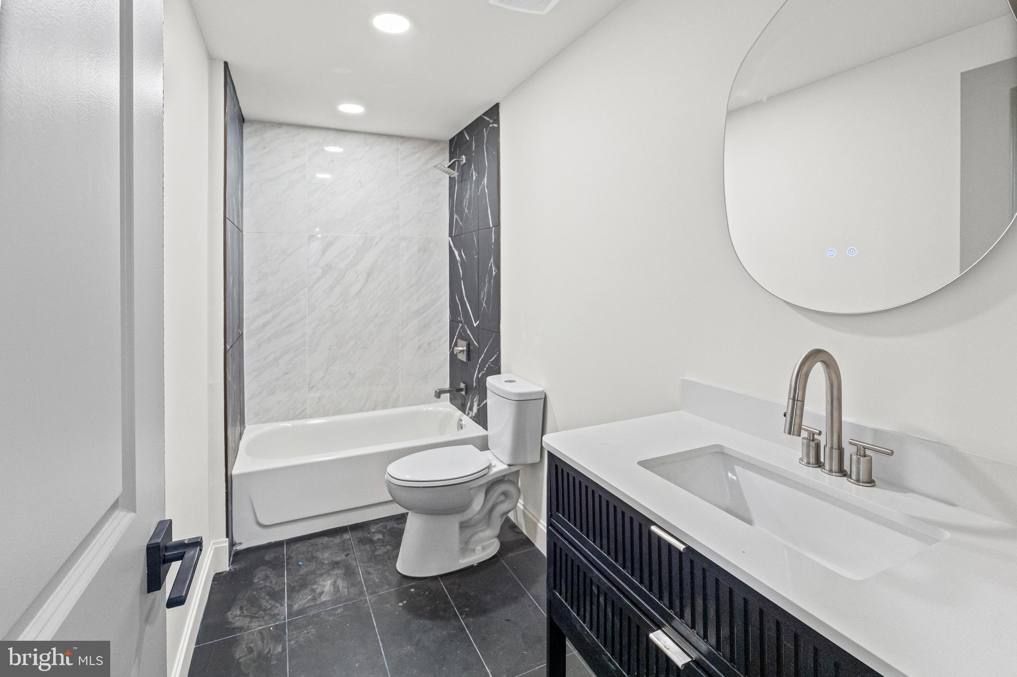 317 South Fulton Avenue Baltimore, MD 21223 - Photo 39 of 44 a bathroom with a double vanity sink toilet and shower