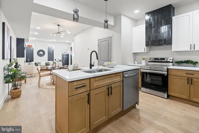 a kitchen with a sink stove and cabinets